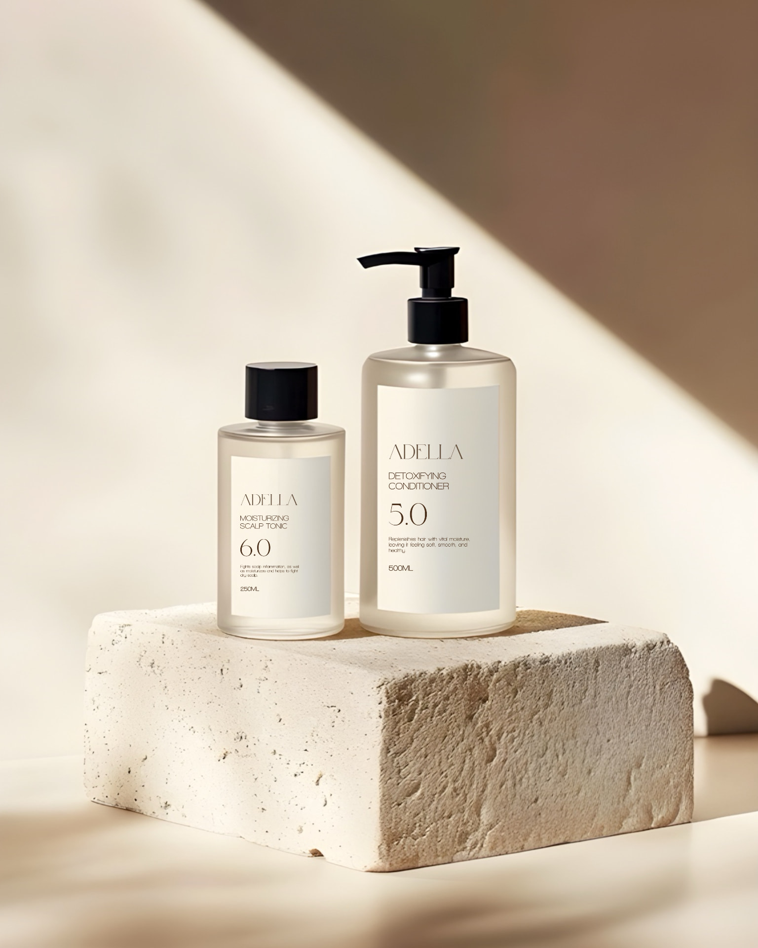 Adella haircare bottles on a stone plinth